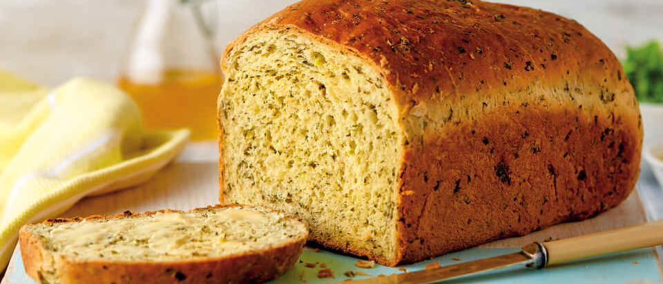 Kale bread with first slice cut. 