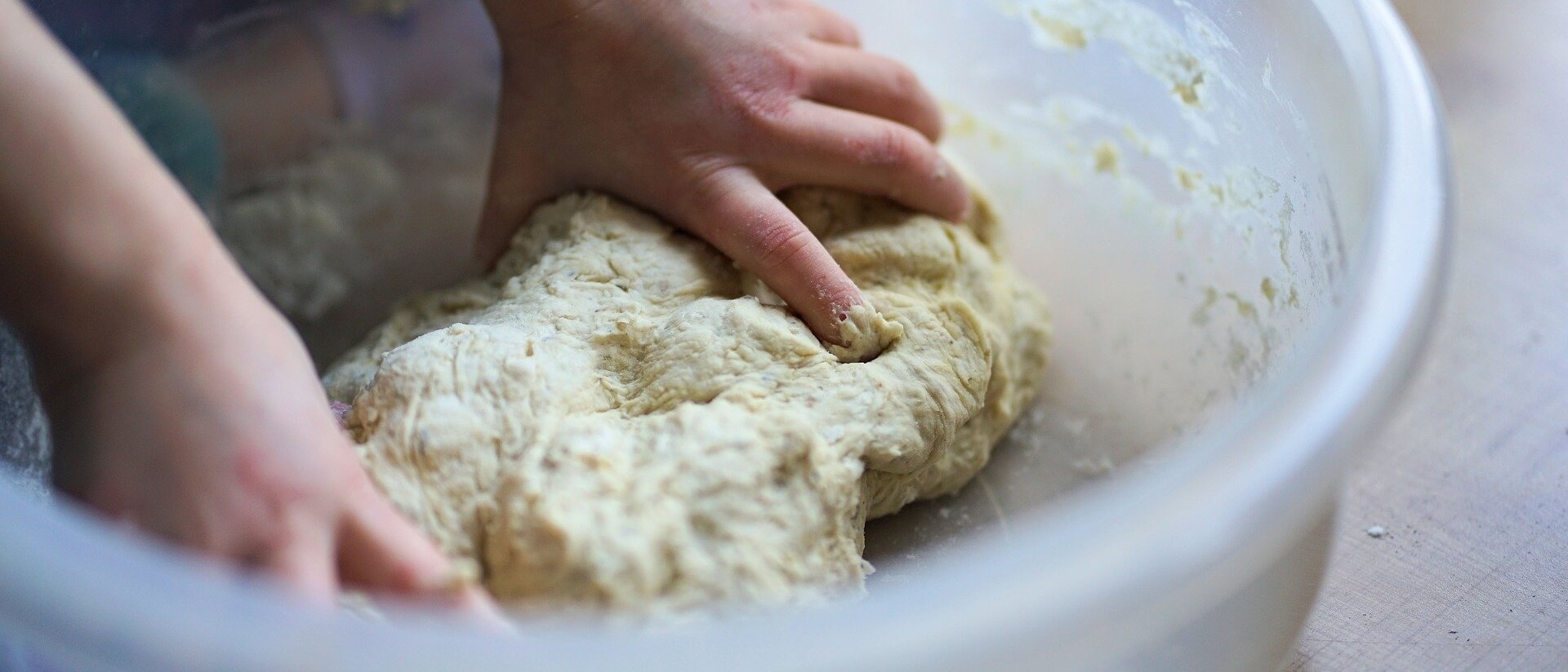 Child kneading dough.