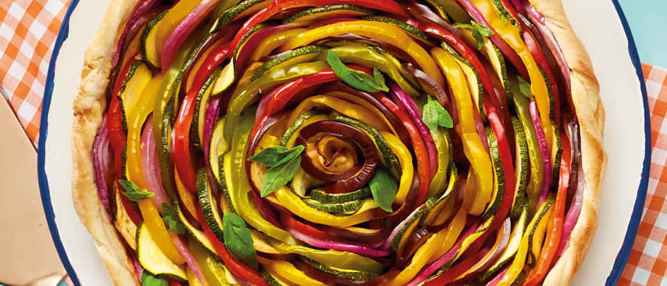 Brightly coloured spiral vegetable tart. 