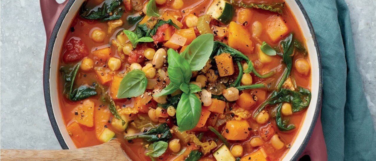 Squash stew with tomatoes, courgette, spinach and chickpeas.